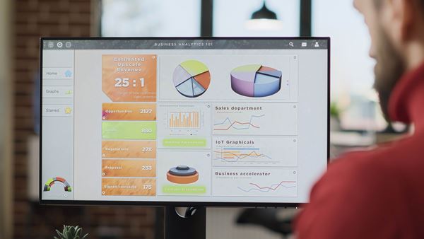 office worker analyzing business charts graphs monitor display planning marketing strategy with financial report data young man working computer with diagram close up